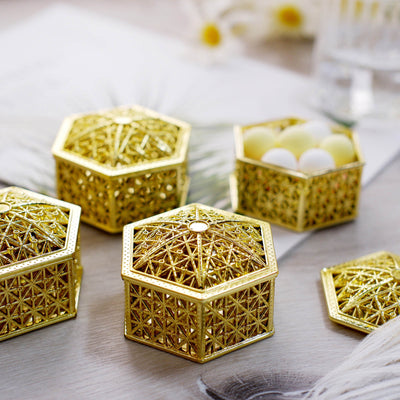 Decorative gold hexagonal boxes with intricate designs.