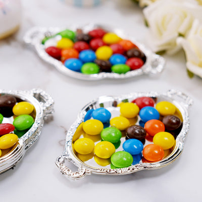 Colorful candy assortment in decorative silver trays.