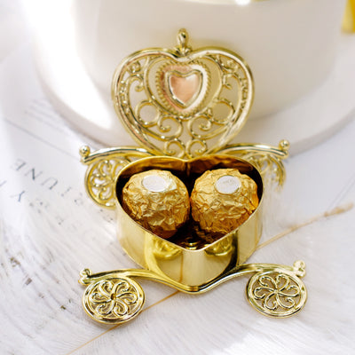 Gold carriage box with two chocolate truffles inside.