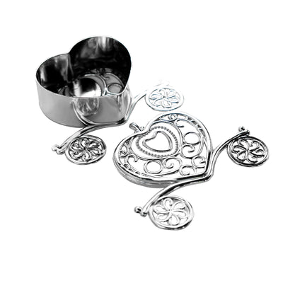Heart-shaped silver cookie cutter and decorative press