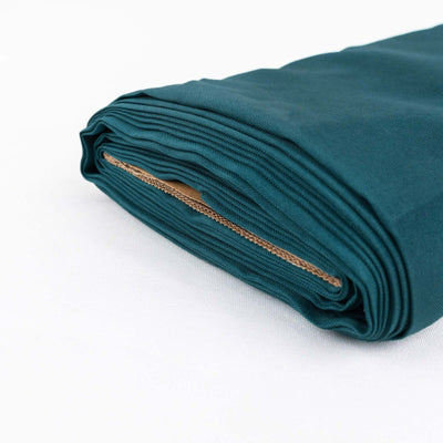 Teal fabric roll on a white background