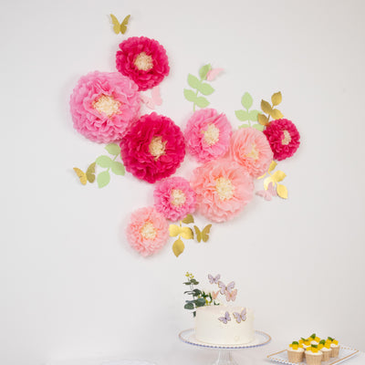 Colorful paper flowers and butterflies decor for celebration backdrop.