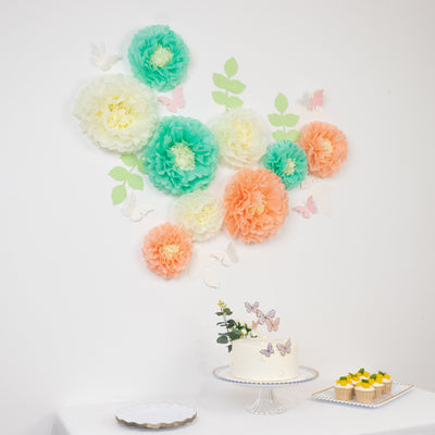Colorful paper flowers and butterflies decor for a festive celebration.