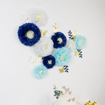 Colorful paper flowers and butterflies on a wall for decoration.