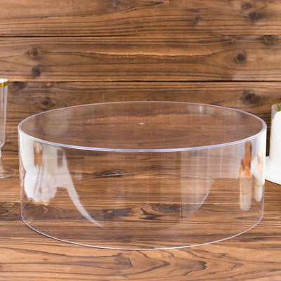 Clear acrylic display riser on a wooden surface.
