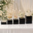 Elegant wedding dessert table with cake, cupcakes, macarons, and white floral decor