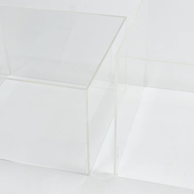 Transparent acrylic display boxes on a white minimalist background
