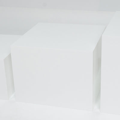 Minimal white geometric cubes in a soft abstract composition