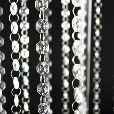 Crystal bead curtain strands hanging elegantly against a dark background.