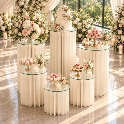 Elegant wedding dessert table with flowers, cake, macarons, and cupcakes