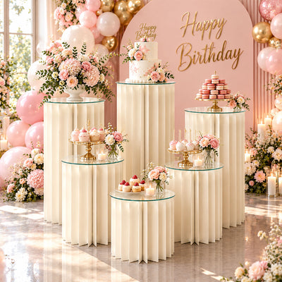 Elegant pink and gold birthday party dessert table with flowers and balloons