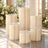 Elegant cream fluted pedestal tables with glass tops in floral event decor