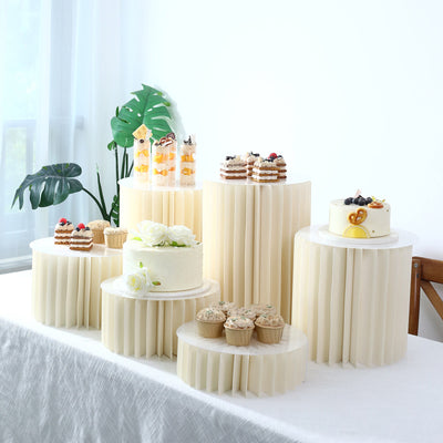 Elegant dessert table with cakes, cupcakes, parfaits, and tropical decor