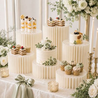 Elegant wedding dessert table with cakes, cupcakes, and floral decor