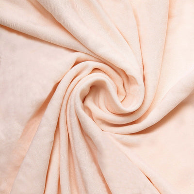 Peach-colored fabric with soft texture in a swirling pattern.