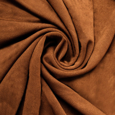 Brown suede fabric in a swirling pattern, showcasing its soft texture and rich color.