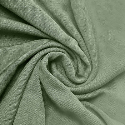 Textured green fabric draped in a spiral pattern.