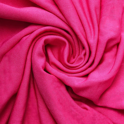 Bright pink fabric texture in a swirling pattern.