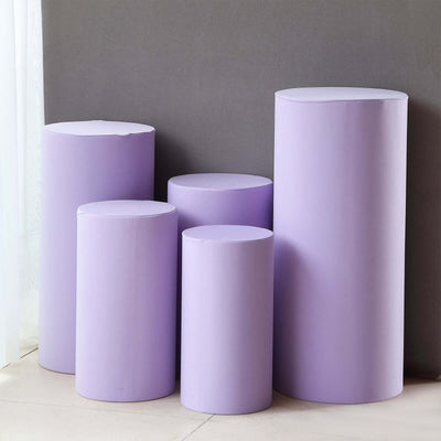 Set of five purple cylindrical display pedestals on a gray background.
