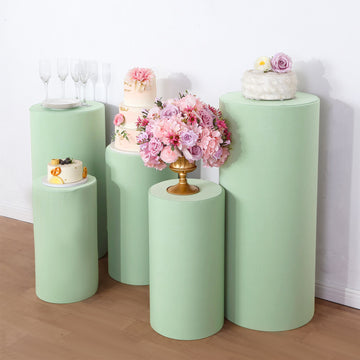 Elevate Your Event with Sage Green Spandex Cylinder Plinth Covers