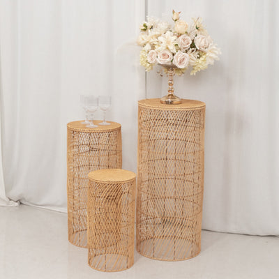 Natural woven side tables with a floral arrangement on top.