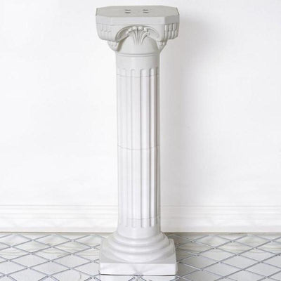 White decorative column pedestal with intricate design details