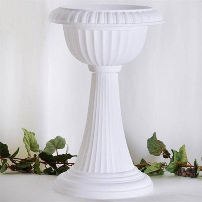 White decorative pedestal planter with fluted design