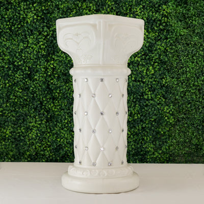 White decorative column with diamond accents and intricate designs.