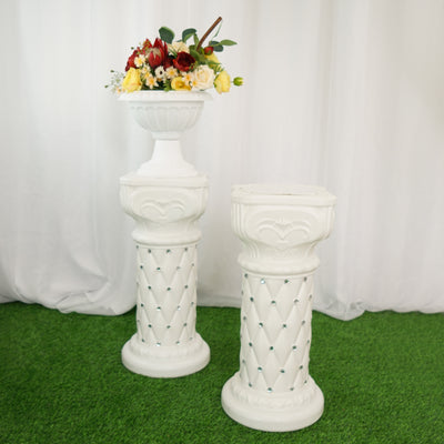 Elegant white flower stands with floral arrangements on top.