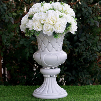 Elegant white rose bouquet in a decorative silver vase.
