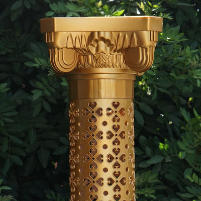 Golden decorative column with intricate patterns and a Corinthian-style capital.