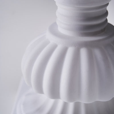 Close-up of a white decorative lamp base showcasing intricate details.