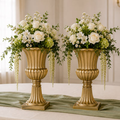 Elegant gold vases with white roses and greenery floral centerpiece arrangement