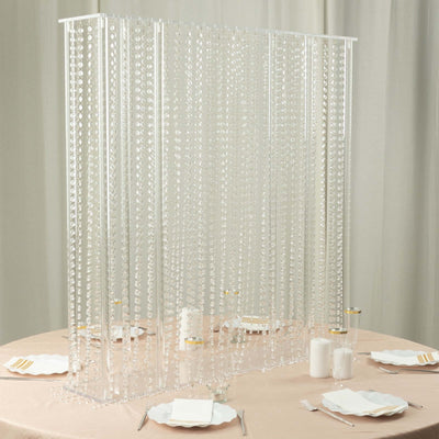 Clear beaded curtain room divider on a table setting.