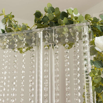Acrylic beaded curtain with greenery accents for home decor.