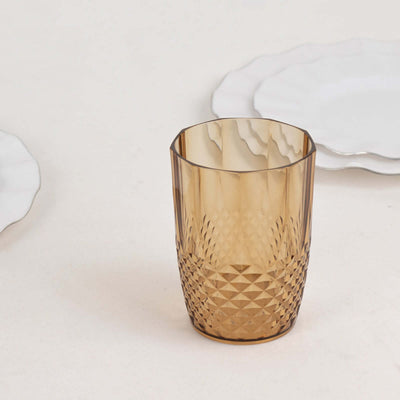 Amber diamond-patterned drinking glass on a neutral backdrop.