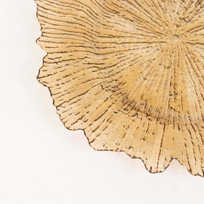 Textured golden decorative plate with a scalloped edge.