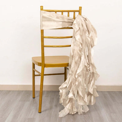 Gold chiavari chair with elegant cream ruffled sash draped over the back.