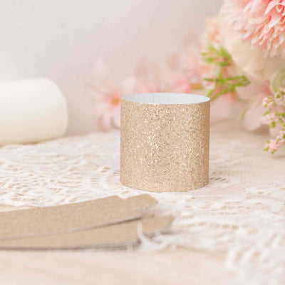 Gold glittered candle holder on lace with floral background.