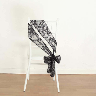 Black lace chair sash with floral design tied in a bow.