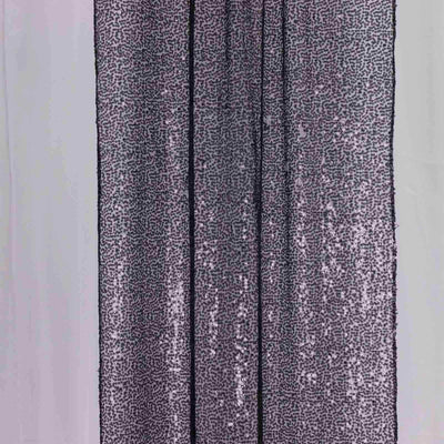 Purple sequin fabric draped elegantly in studio-style isolation.