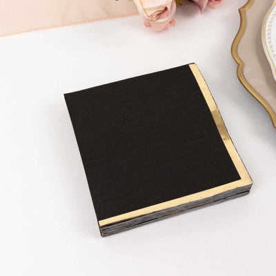 Black notebook with gold corner accents on a white background.