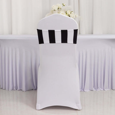 White chair cover with black striped sash on a banquet table.
