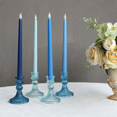 Elegant blue and teal glass candle holders with decorative candles.