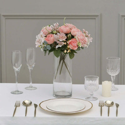 Elegant floral centerpiece with table setting and glassware.