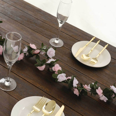 Elegant table setting with gold utensils and floral decor.