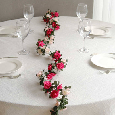 Floral table centerpiece with pink and white flowers on a dining table.