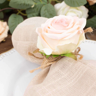 Decorative burlap napkin ring with a pink rose accent.