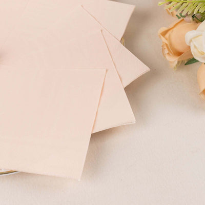 Soft pink napkins arranged elegantly on a table.