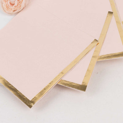 Pink envelopes with gold foil edges on a white background